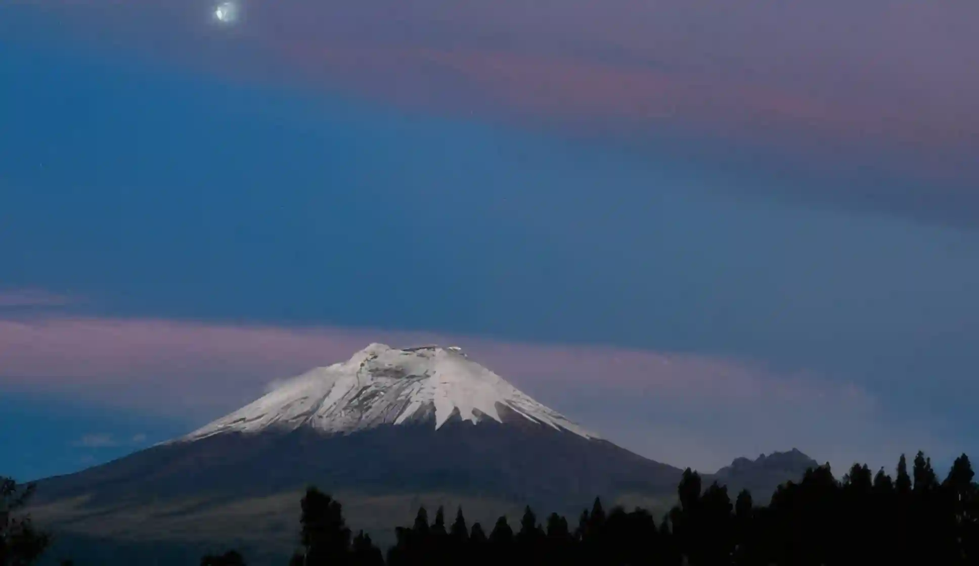 El volcán Cotopaxi nevado al atardecer, visto desde el cantón Latacunga